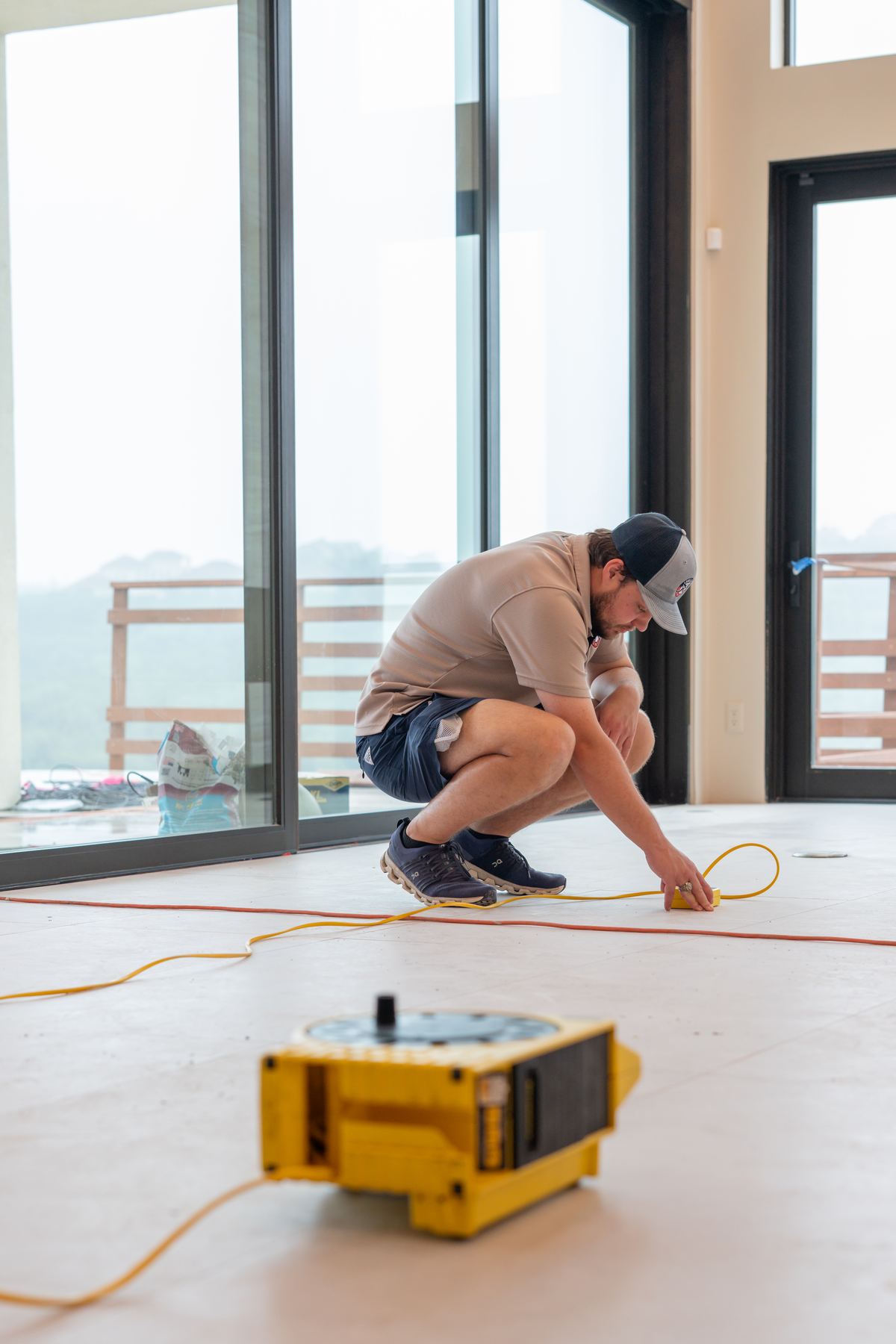 Home inspector measuring floor elevations to document foundation movement