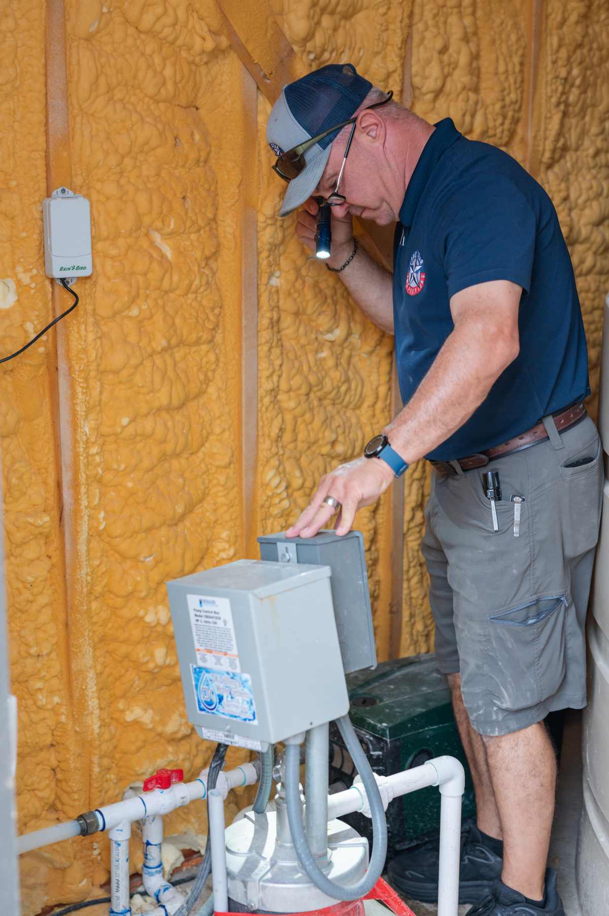 Inspector checking ductwork and insulation in a new construction attic in Taylor, TX