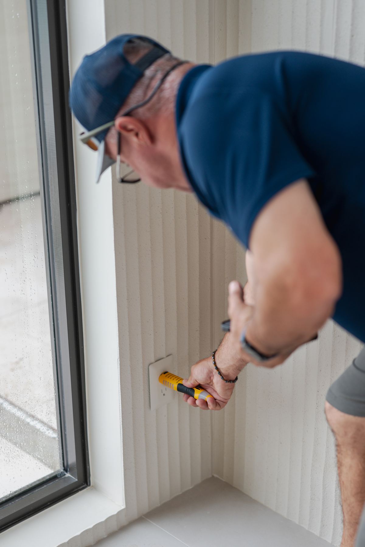 Inspector testing an electrical outlet during a new construction inspection